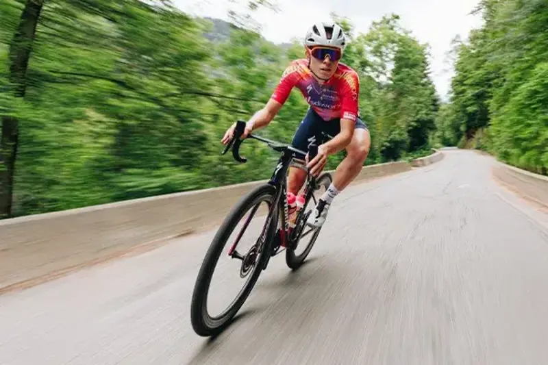 Rider turning in to a corner on the Specialized Tarmac SL8 road bike