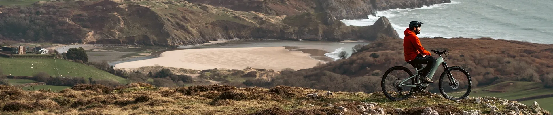 Specialized Turbo Levo R full-power electric mountain bike rider overlooking a mountain trail in Wales