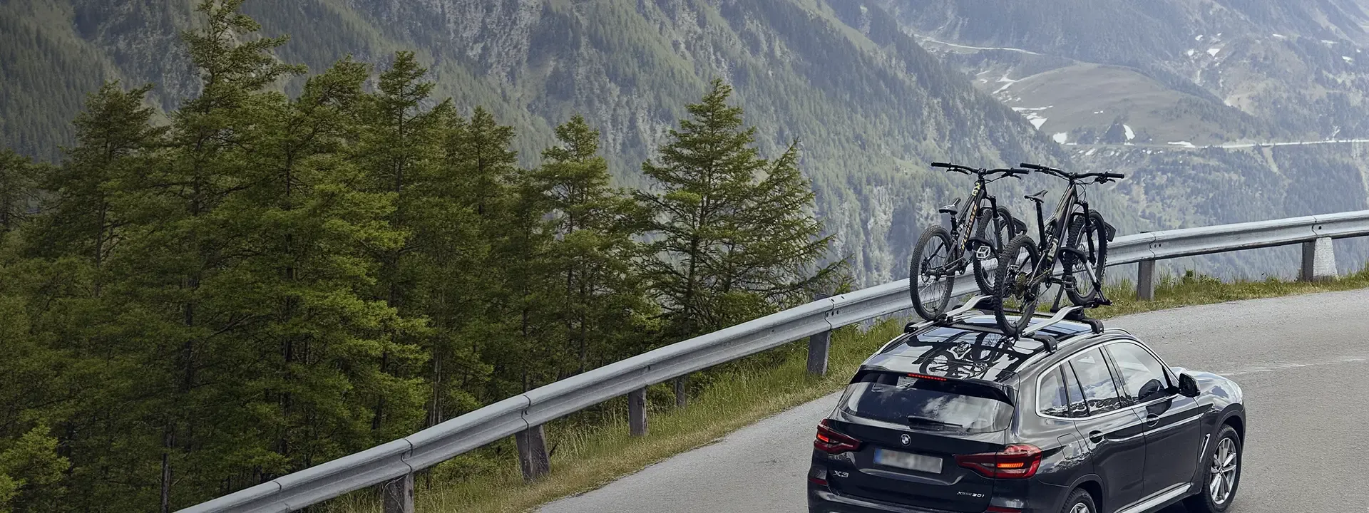 Bicycle secured to a roof-mounted car bike rack