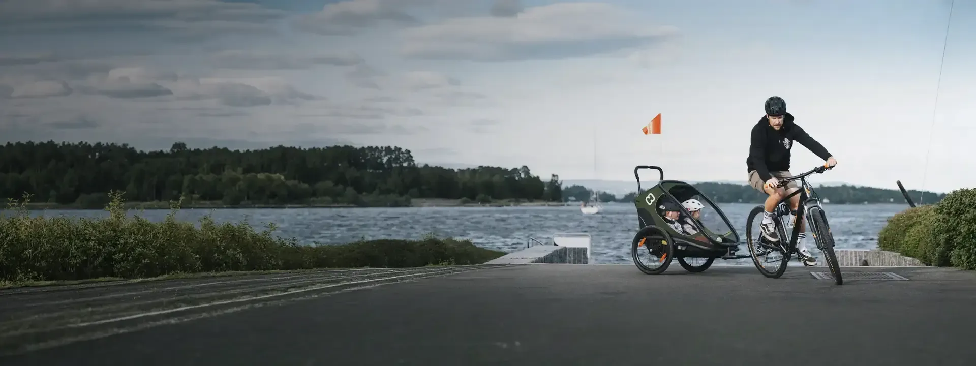 Cyclist towing a child trailer on a family bike ride