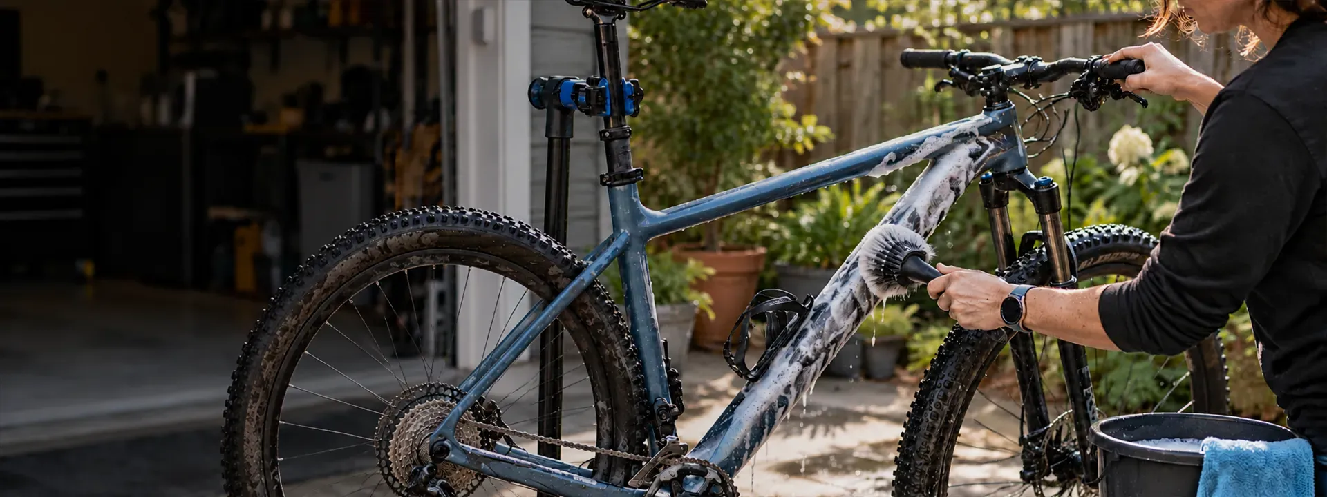 A rider gently cleaning a bicycle in a home garden setup
