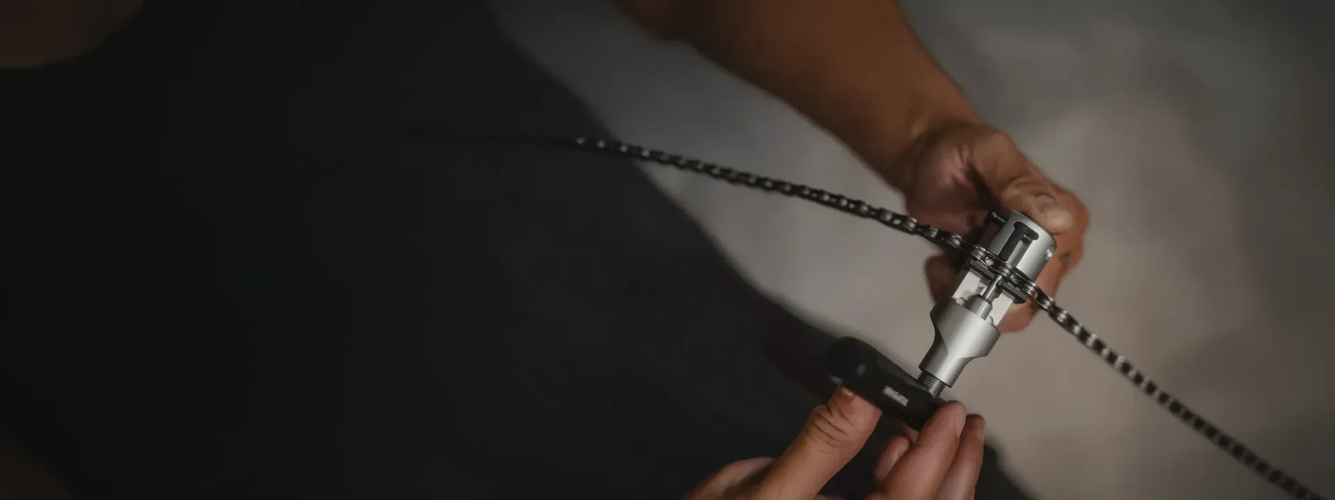 A bicycle chain tool being used to work on a chain
