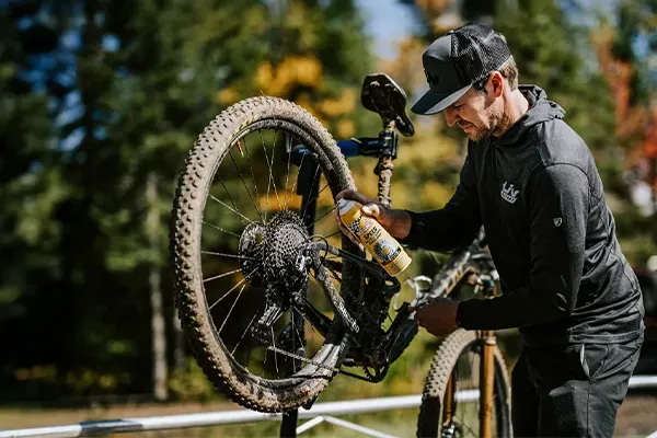 A rider caring for a bike outdoors
