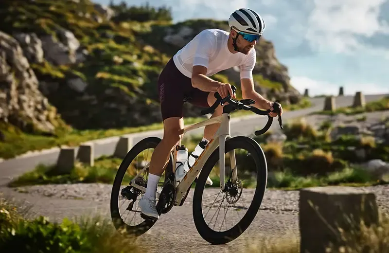 Cyclist descending a mountain road ona Trek Domane SLR carbon road bike