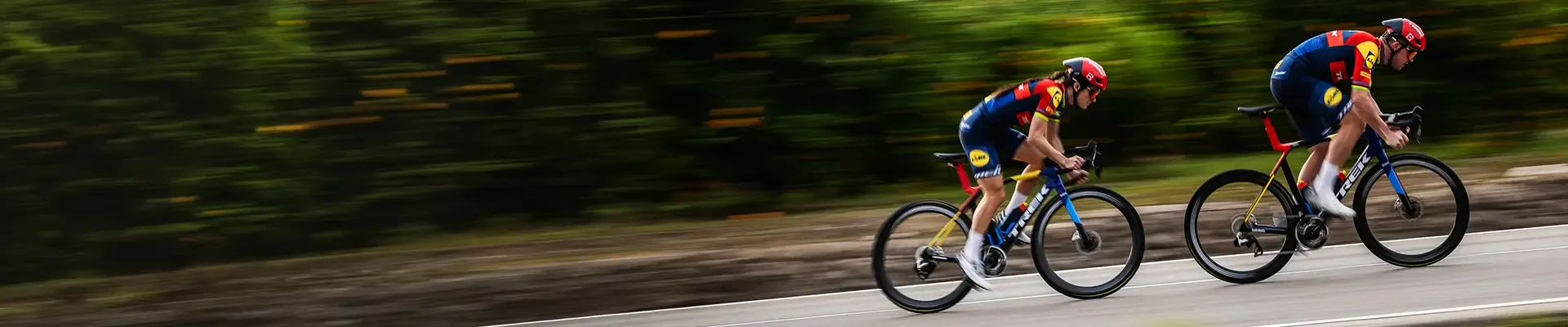 Lidle Trek riders on Trek Madone road bikes being cycling at speed on an open road