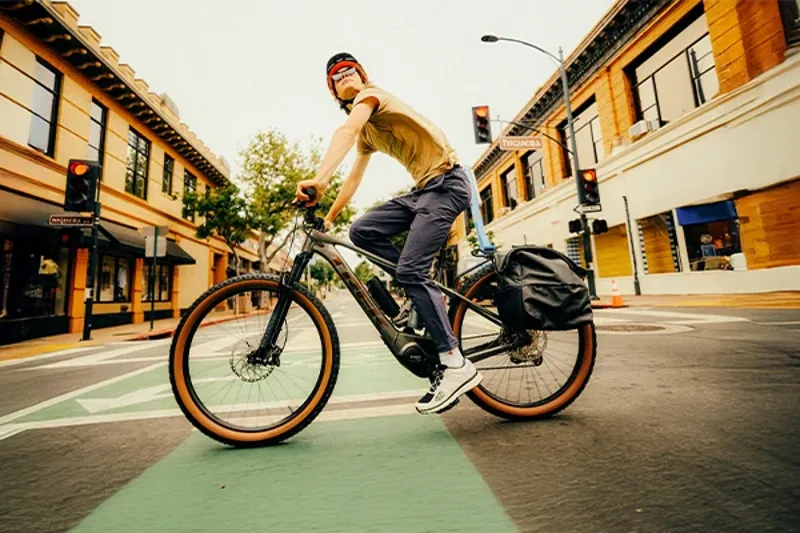 Cycling on a Trek Marlin+ with pannier bags for commuting and everyday riding