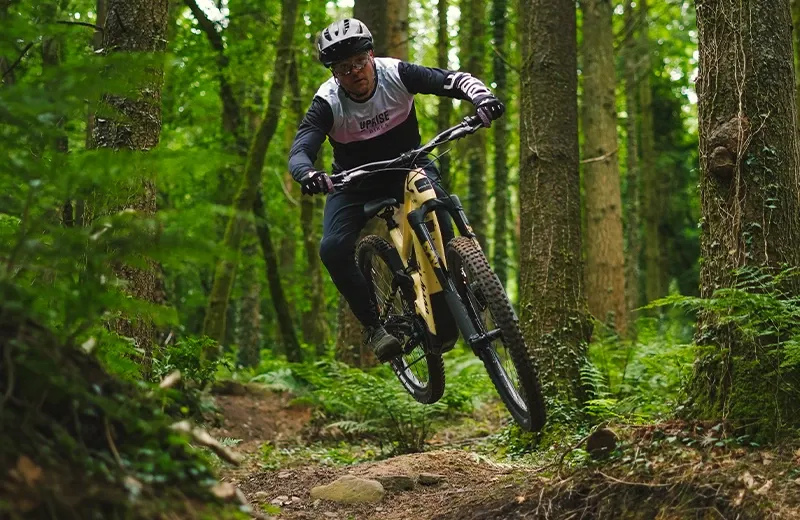 Whyte Kado eMTB jumping through technical trail section